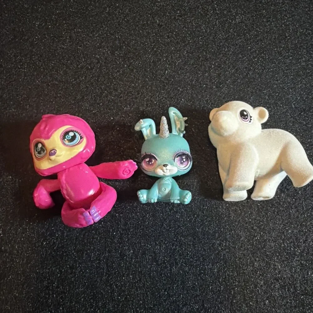 three small collectible toy figurines: Baby Crystals, Bounce Scribble Scrubbie k